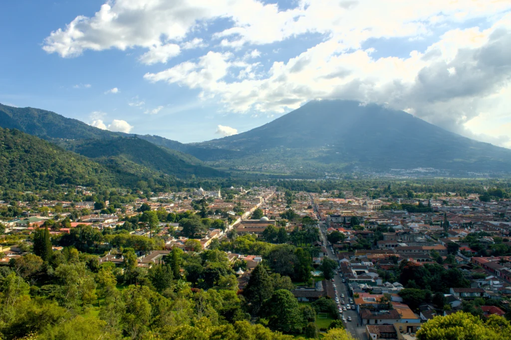 Rooftops of Antigua Guatemala below Volcán de Agua, seen from the surrounding hills