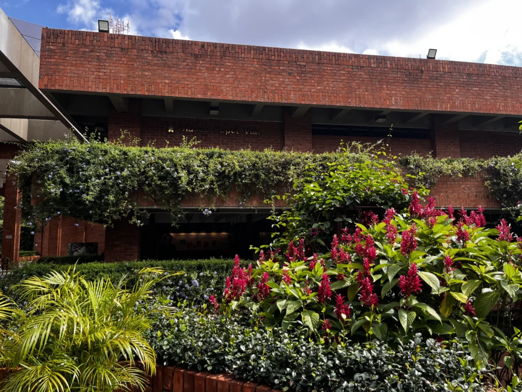 Entrance of the Museo Popol Vuh behind flowering plants, Guatemala City